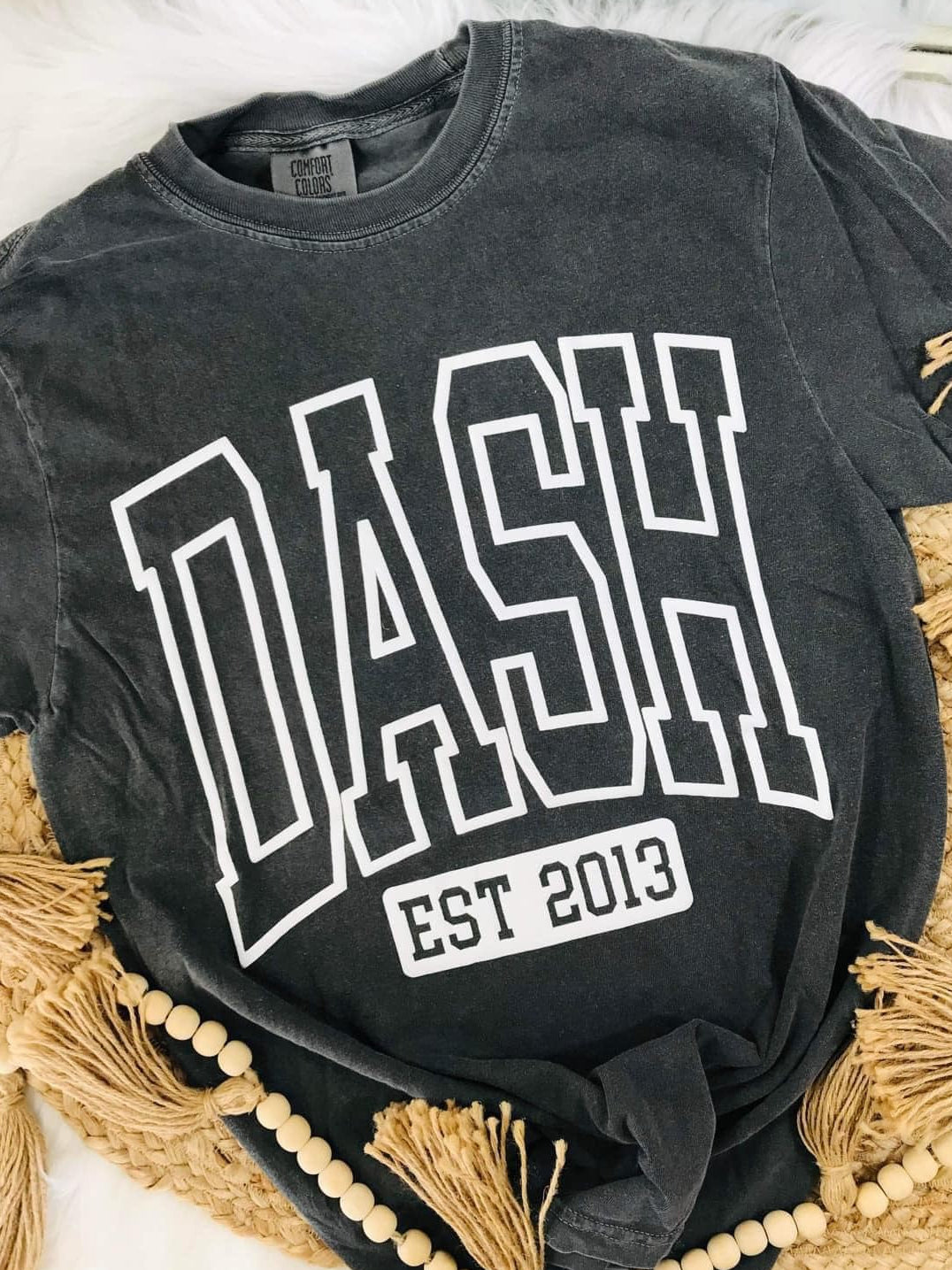 Black t-shirt with 'DASH EST 2013' text on a textured surface