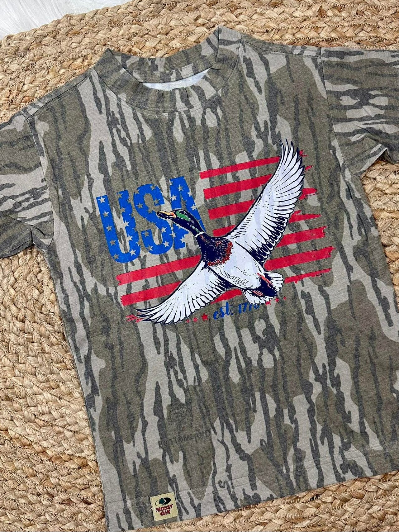 Camouflage t-shirt with USA and mallard duck like eagle design on a woven mat