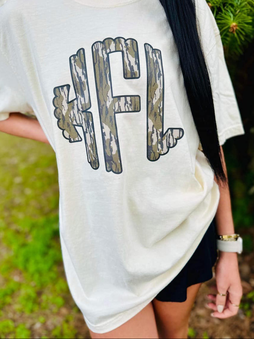 Person wearing a white t-shirt with a graphic design outdoors