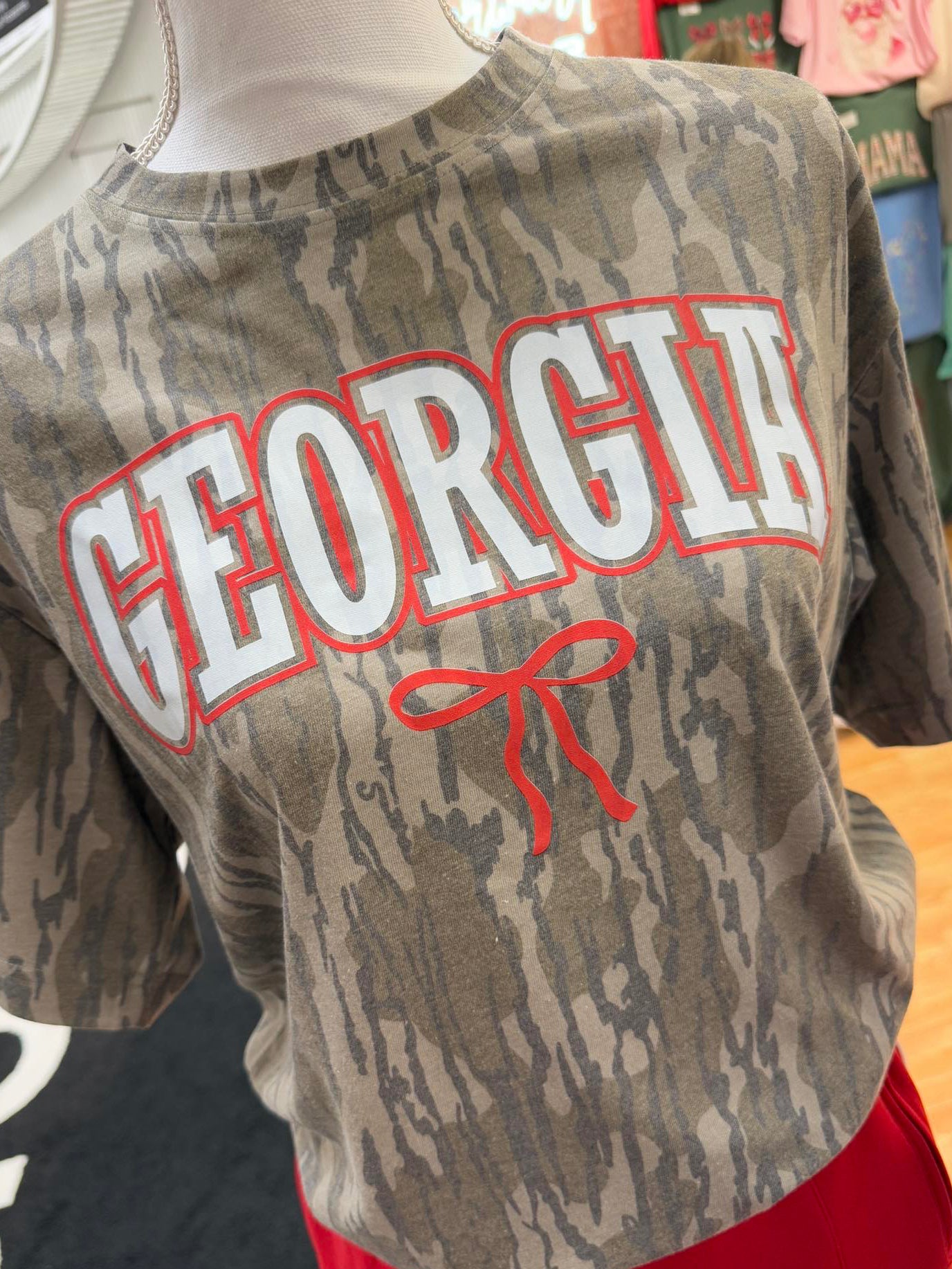 Mossy Oak Bottomland Camouflage shirt with 'Georgia' text on a mannequin