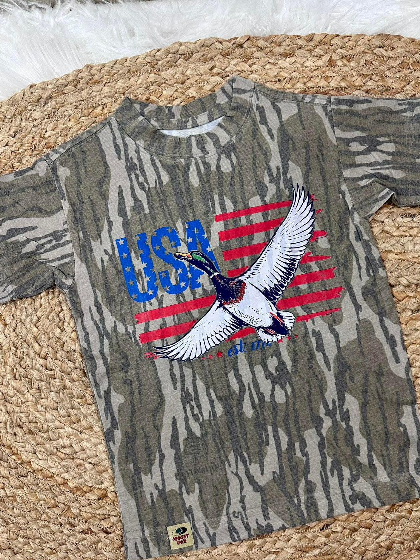 Camouflage t-shirt with USA and mallard duck like  eagle design on a woven mat