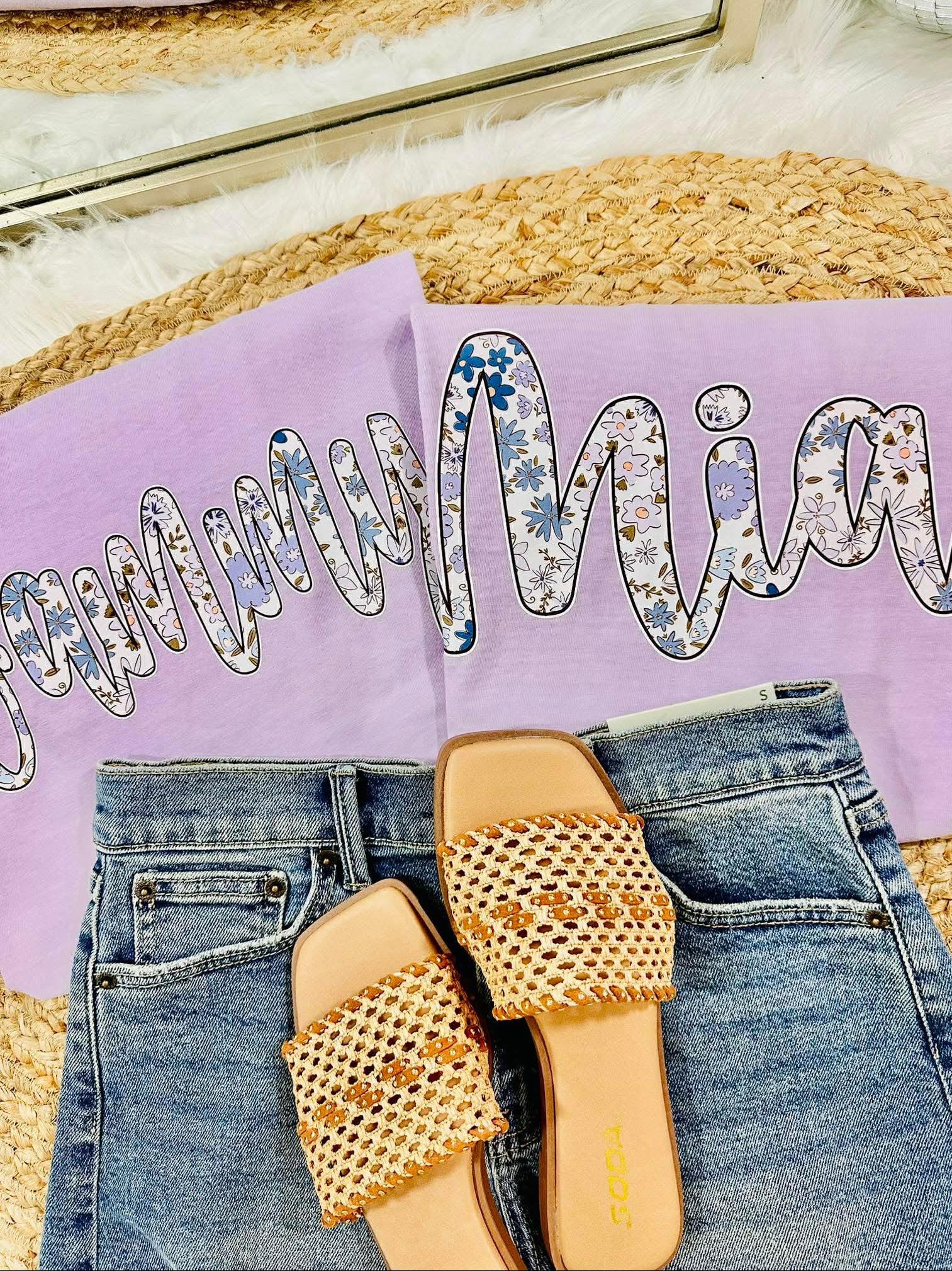Pair of beaded sandals on jeans with a purple pillow and decorative text in the background