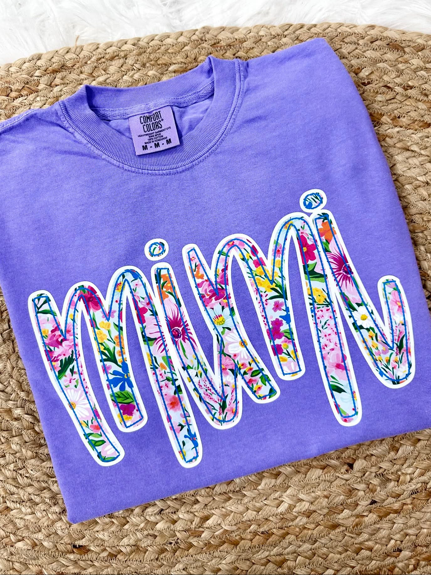 Violet Purple Comfort Color tee sweatshirt with floral pring 'MiMi' dtf graphic text on a textured surface